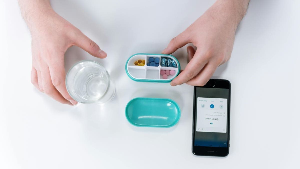 A woman who uses a health app to keep track of the tablets